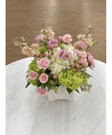 Collection of pink fresh-cut flowers accented with creams and whites